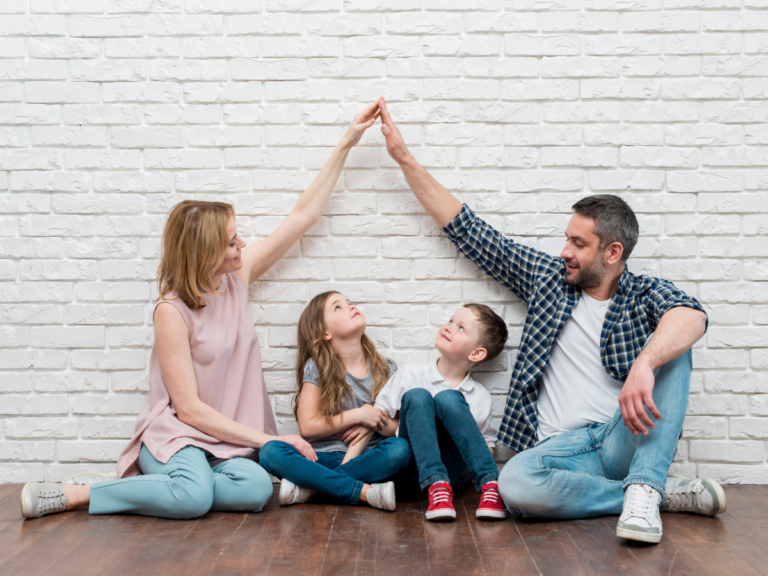 Family making a house with their arms over their children